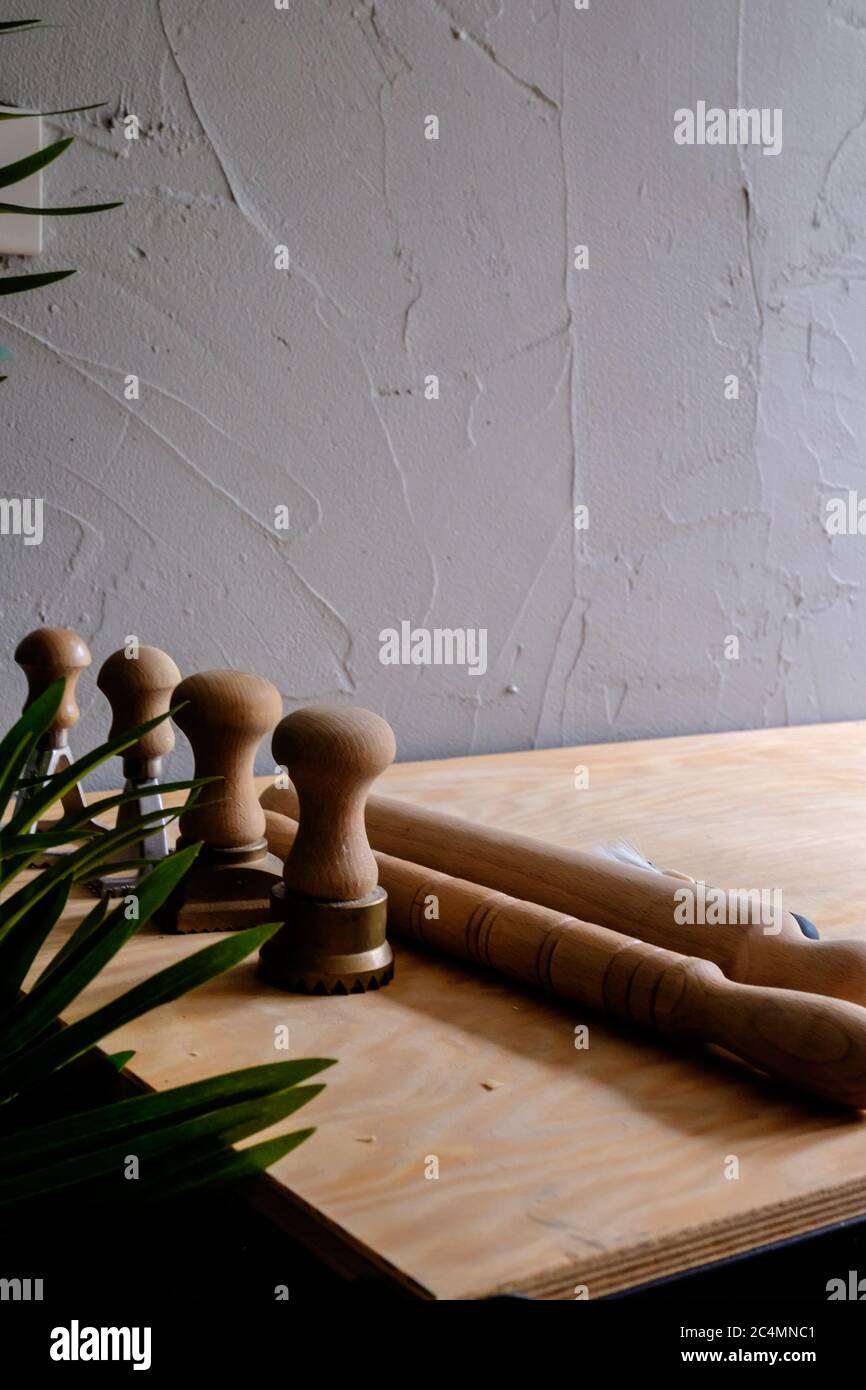 View of A set of pasta creating tools, including rolling pins and metal molds ...
