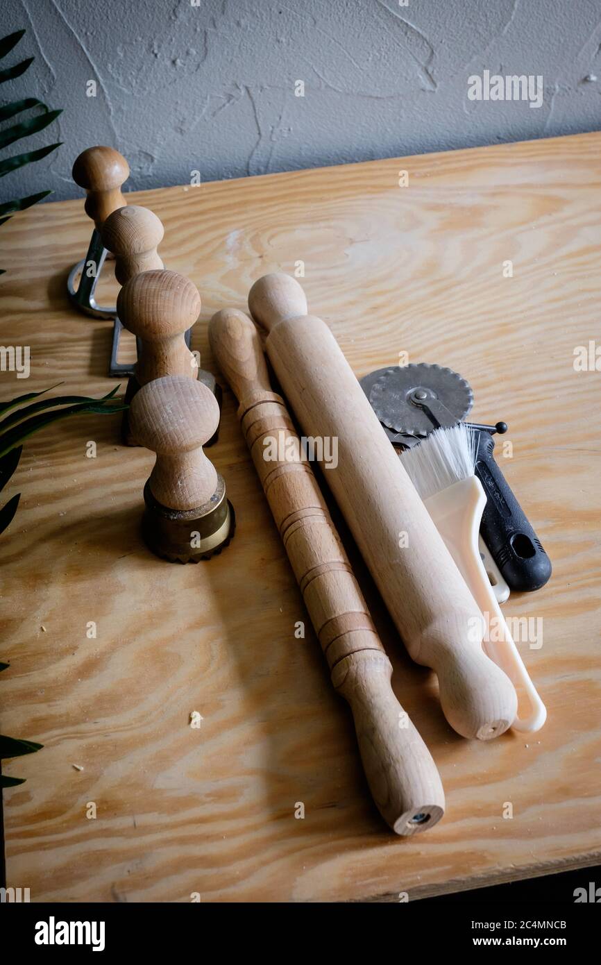 A set of pasta creating tools, including rolling pins and metal molds