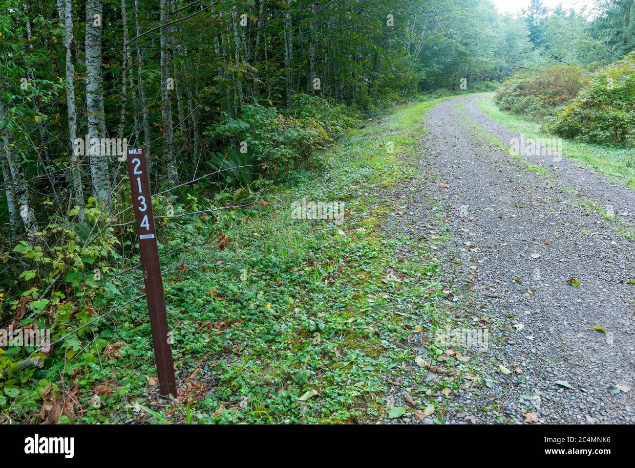 A mileage marker on an abandoned railroad line that was converted to a state park trail in Washington, USA Stock Photo