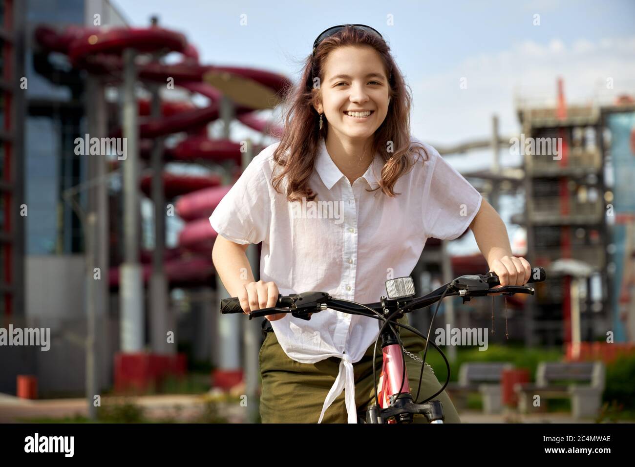 Urban biking teenage girl, bike in city. Active lifestyle. Stock Photo
