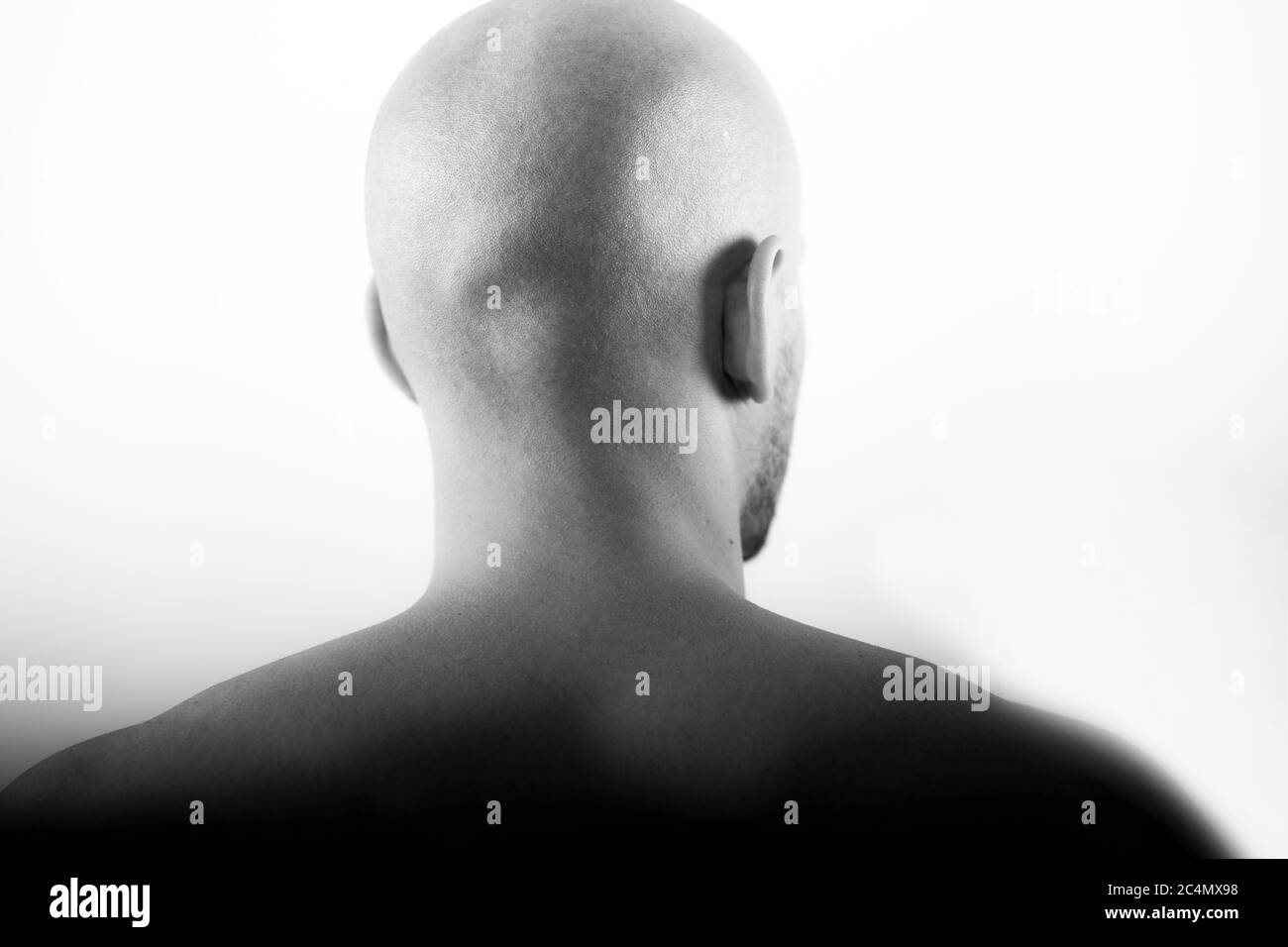 shaved head behind statue clean baldness skinhead Stock Photo