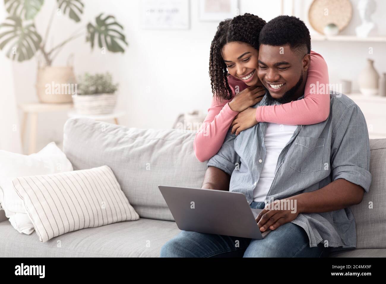 Happy African American Couple Browsing Internet On Laptop At Home Stock ...