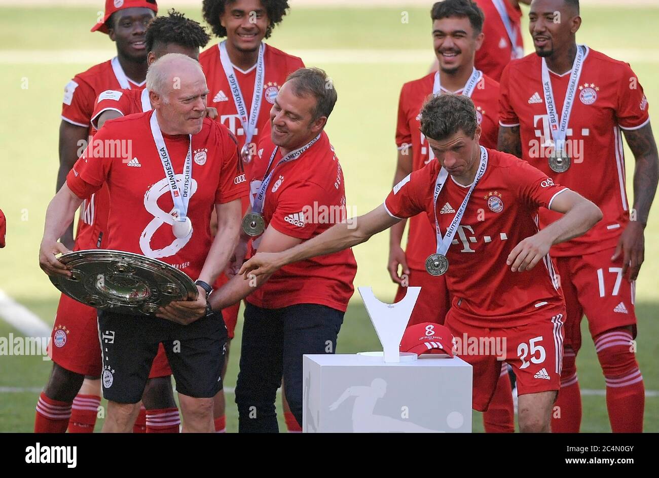 Wolfsburg, Germany, 27 th June 2020,  Winners ceremony after the match: Its the 30 th championship title for FCB.   Trainer Hansi FLICK (FCB), team manager, headcoach, coach,  FCB Co-Trainer Hermann GERLAND, fight for the trophy, Thomas MUELLER, MÜLLER, FCB 25  at the 1.Bundesliga match  VFL WOLFSBURG - FC BAYERN MUENCHEN 0-4 in season 2019/2020 am matchday 34. FCB Foto: © Peter Schatz / Alamy Live News / Bernd Feil/MIS/Pool   - DFL REGULATIONS PROHIBIT ANY USE OF PHOTOGRAPHS as IMAGE SEQUENCES and/or QUASI-VIDEO -   National and international News-Agencies OUT  Editorial Use ONLY Stock Photo
