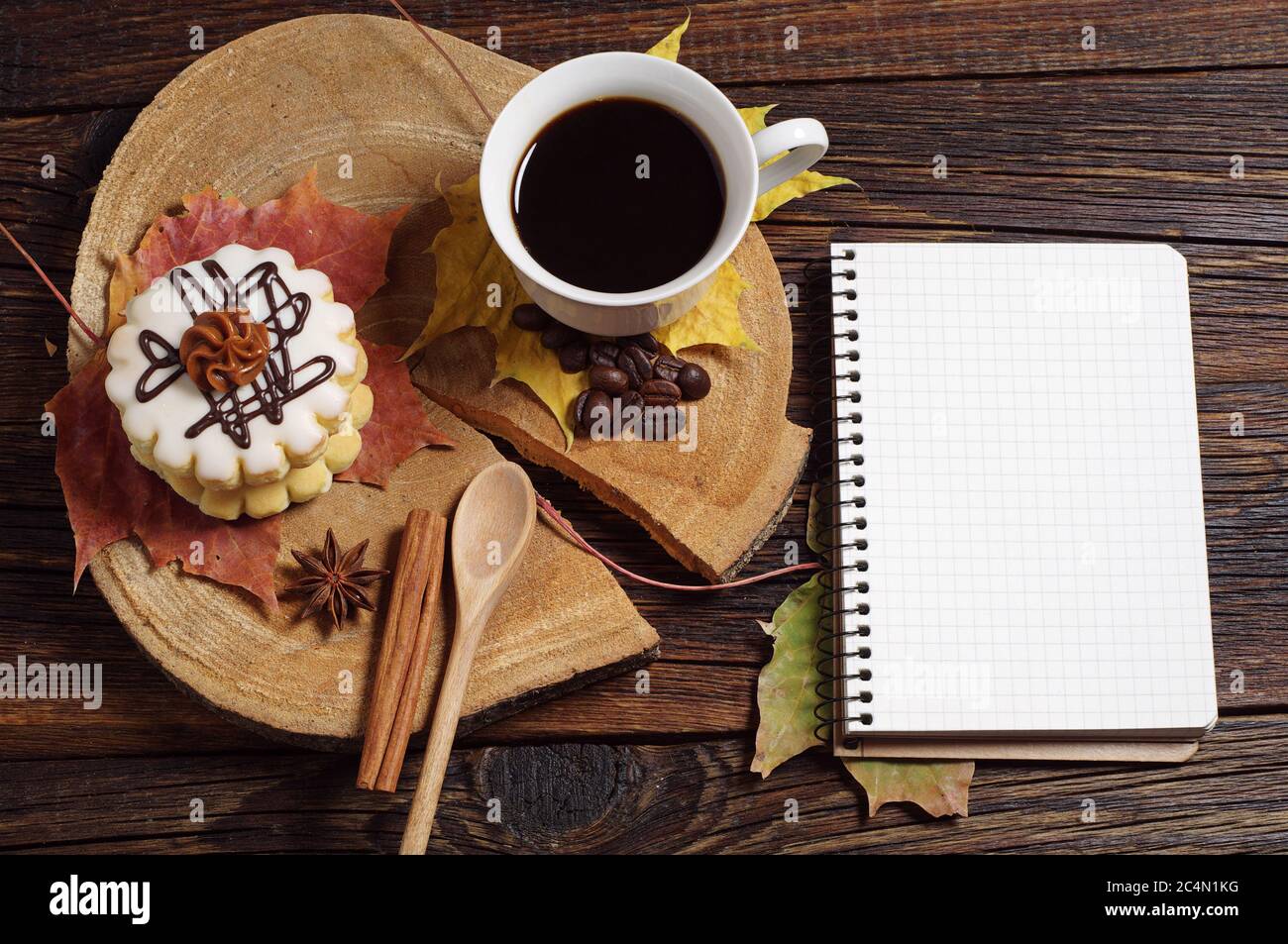 Cup of coffee with cake and notebook on old wooden background Stock Photo