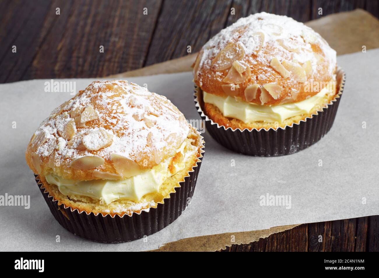 Two cake with whipped cream and almonds on table Stock Photo Alamy