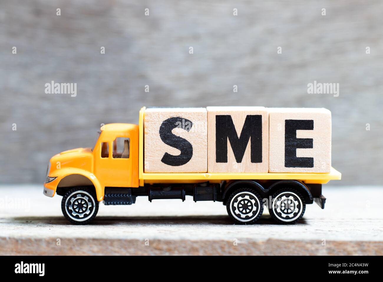 Truck hold letter block in word SME (abbreviation of Small and medium