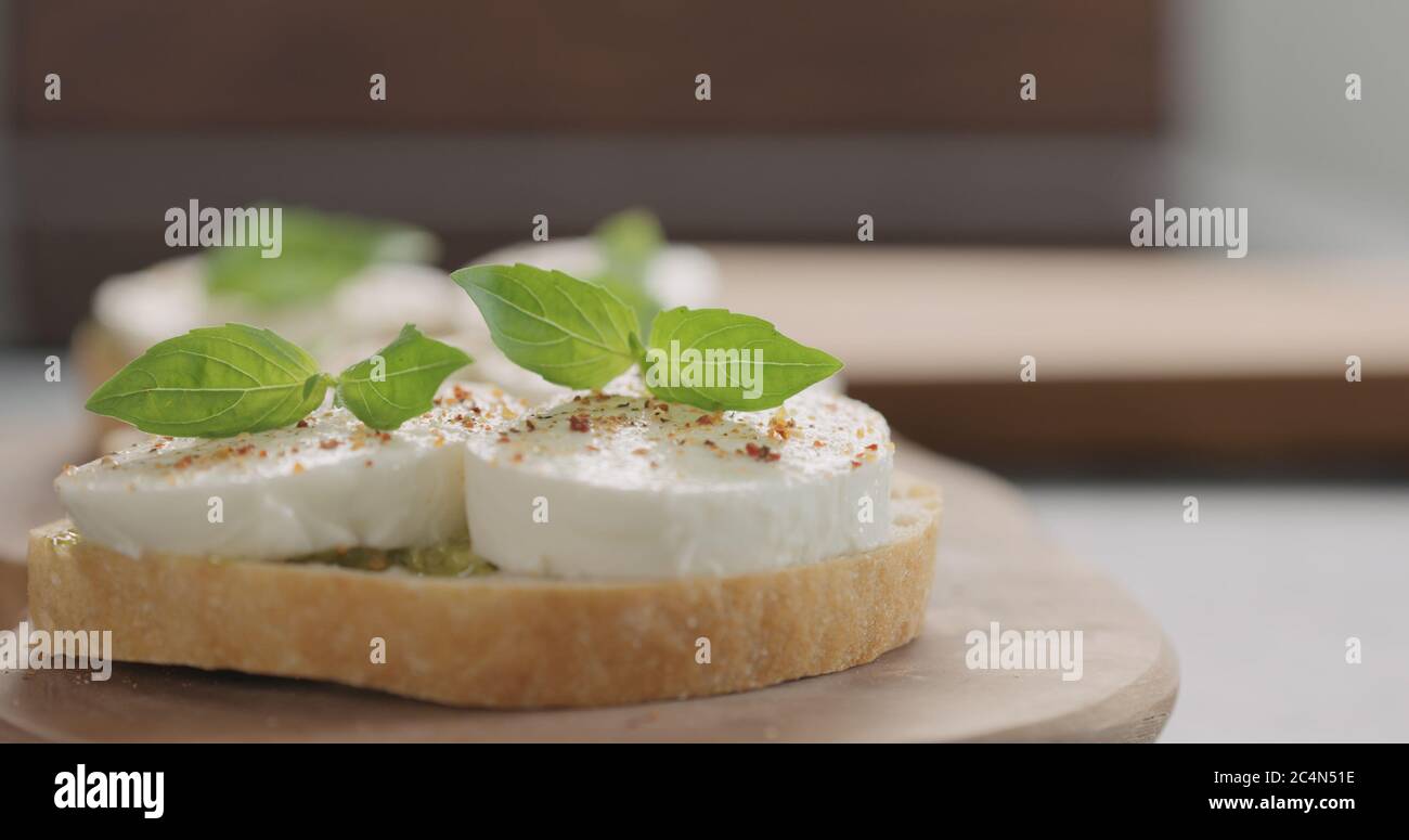 bruschetta with pesto and mozzarella on olive board Stock Photo Alamy