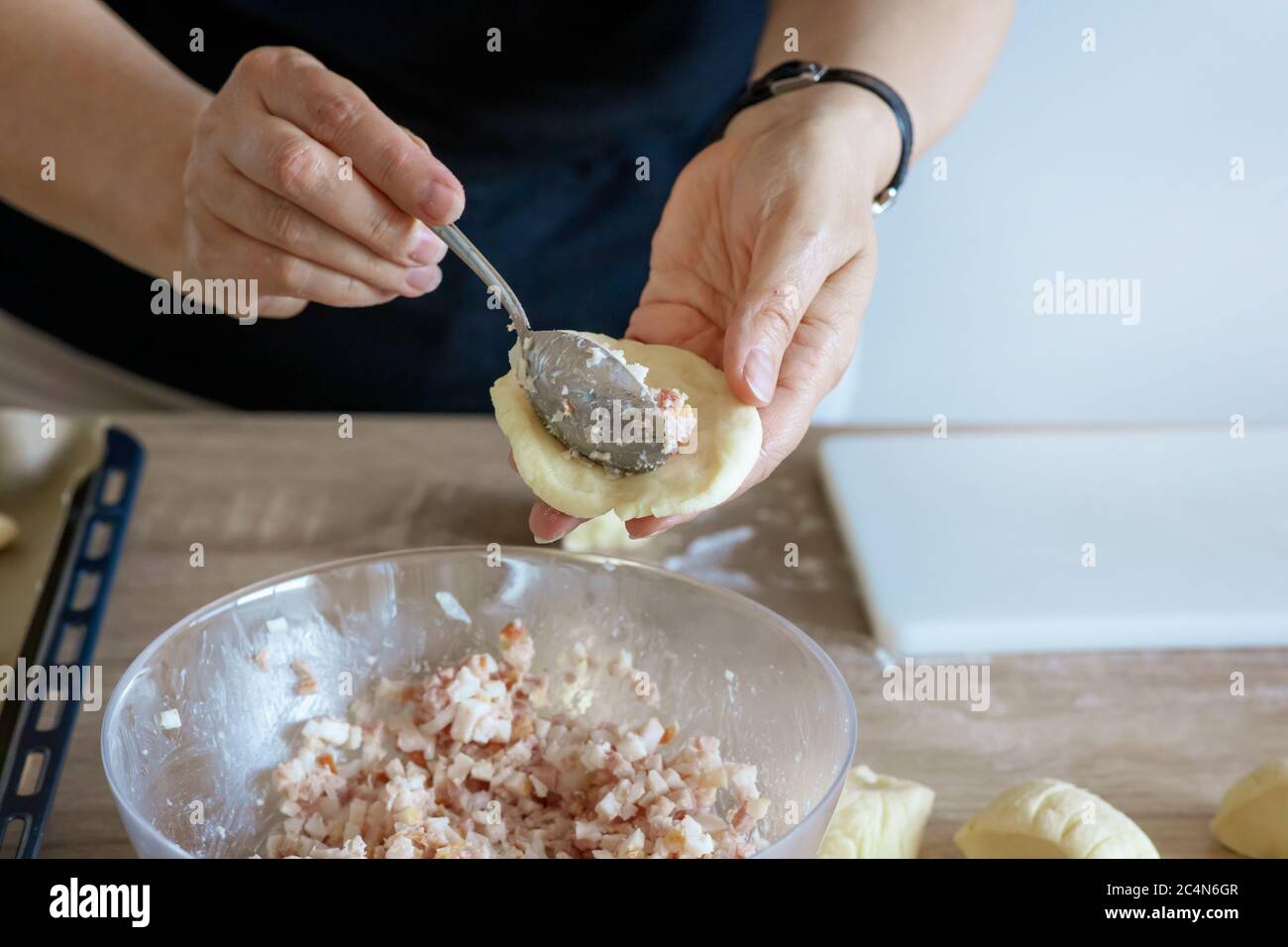 bacon is stuffed in yeast dough, preparation of meat pies Stock Photo