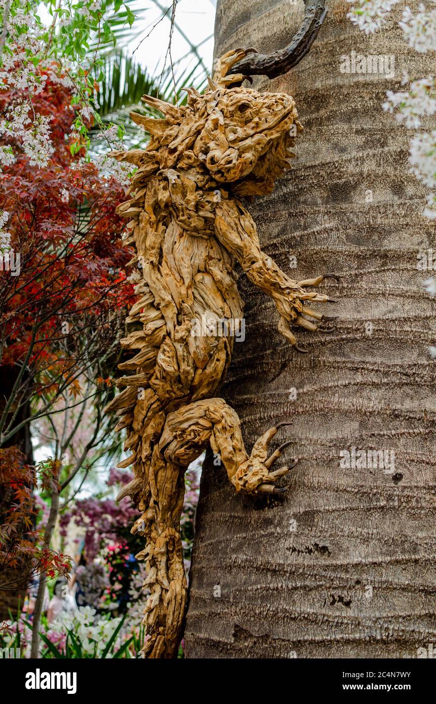 Wood carving of a lizard in Singapore Gardens by the Bay flower dome Stock Photo