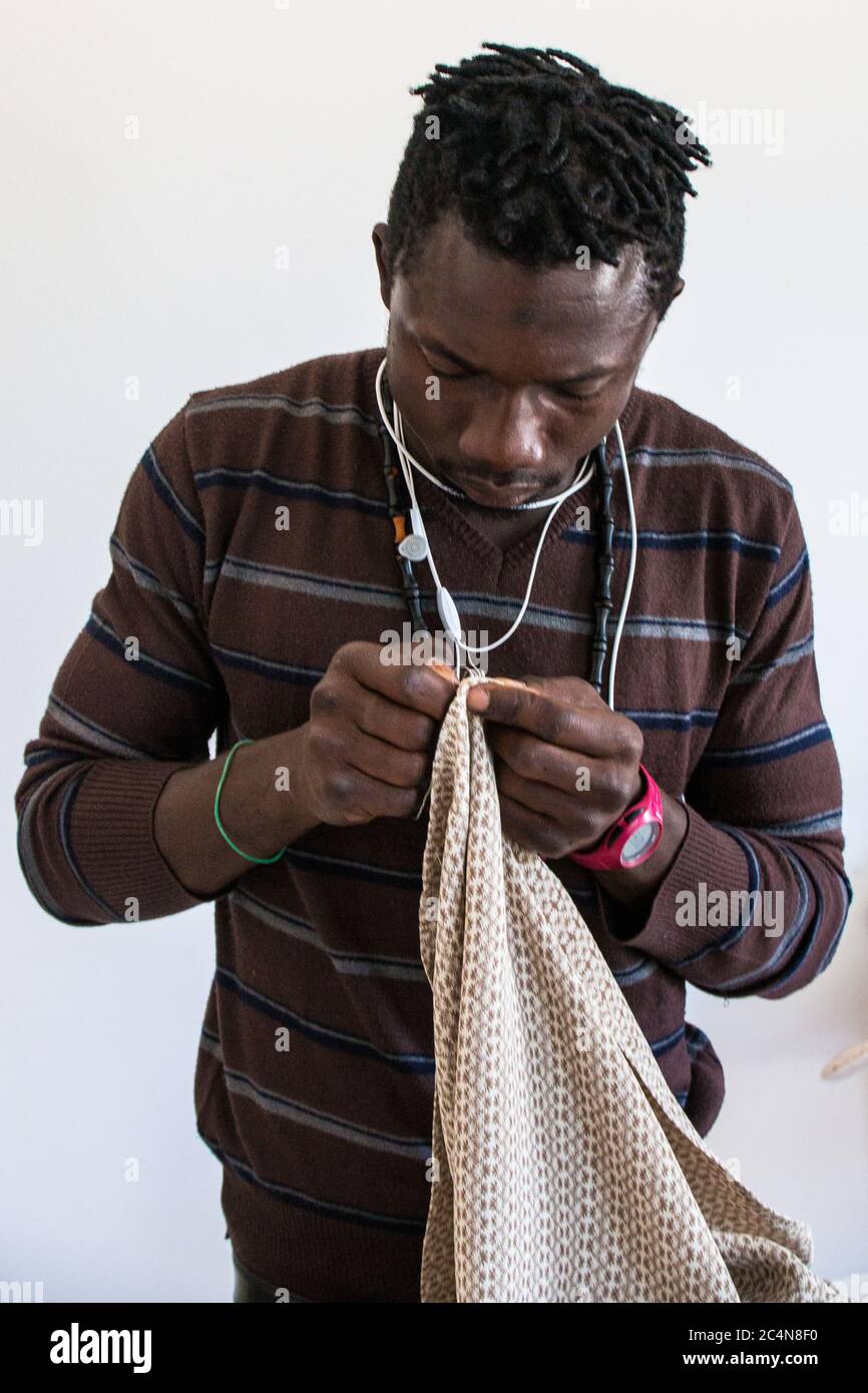 political refugees and African immigrants working on tailoring of the