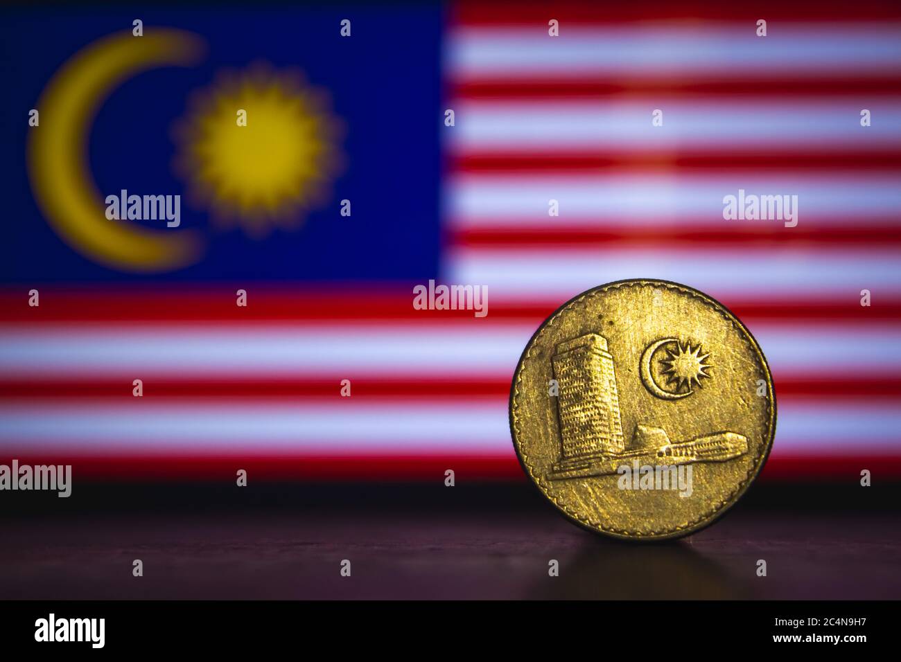 Malaysian coin - Malaysia 20 Sen 1973 coin isolated on malaysia flag background. Malaysian currency twenty sen coin with space for text copy. Stock Photo