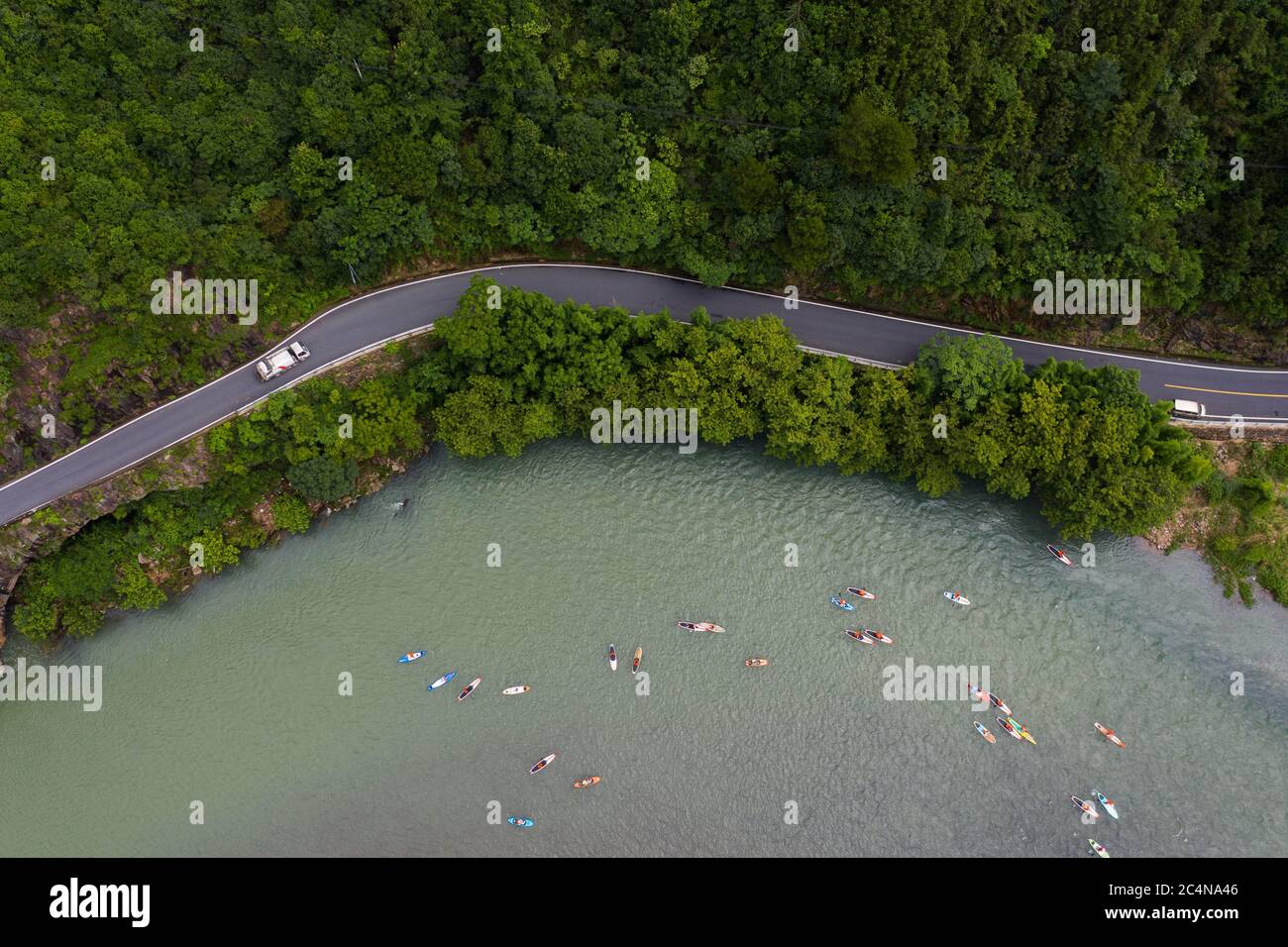 Hangzhou, China's Zhejiang Province. 28th June, 2020. Aerial photo shows water sports enthusiasts participating in a paddleboarding activity on the Huyuan River in Huyuan Township of Fuyang District, Hangzhou, east China's Zhejiang Province, June 28, 2020. Township-level governments in Fuyang District have worked in collaboration to maximize the Huyuan River's ecological resources and promote local ecotourism. Credit: Xu Yu/Xinhua/Alamy Live News Stock Photo