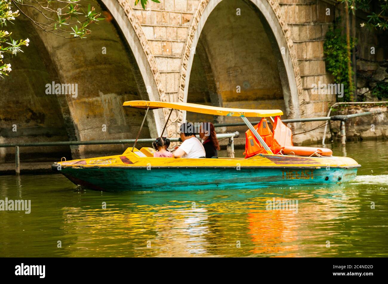 A family enjoying a pleasure boat on the lake in Shanghai’s Lu Xun Park. Stock Photo