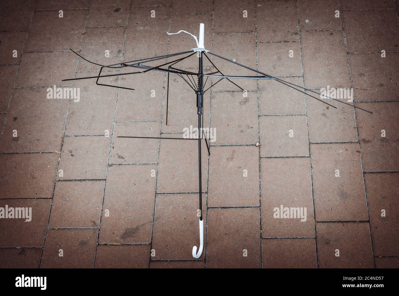 Metal white and black umbrella frame on the ground Stock Photo