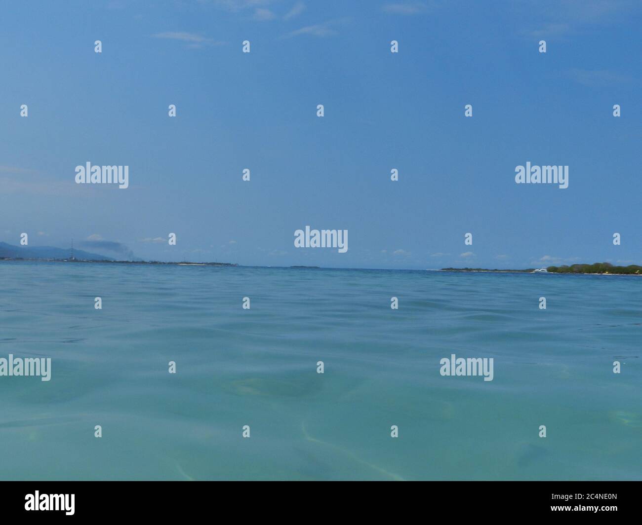 Calm sea with a clear blue sky background Stock Photo - Alamy