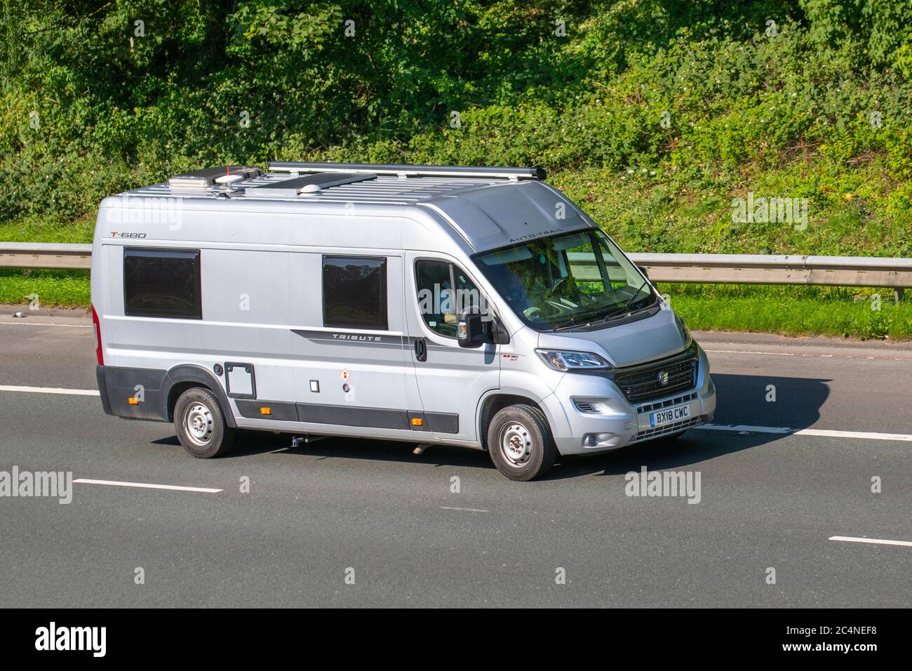 2018 silver Fiat Auto-Trail Tribute T680 S; Vehicular traffic moving vehicles, cars driving vehicle on UK roads, motors, motoring on the M6 motorway highway network. Stock Photo