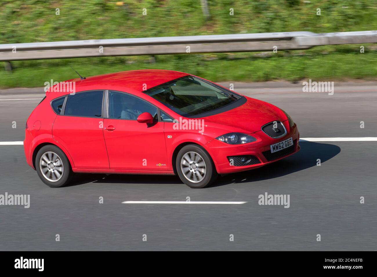 2012 red SEAT Leon SE Copa CR TDI;Vehicular traffic moving vehicles, cars driving vehicle on UK roads, motors, motoring on the M6 motorway highway network. Stock Photo