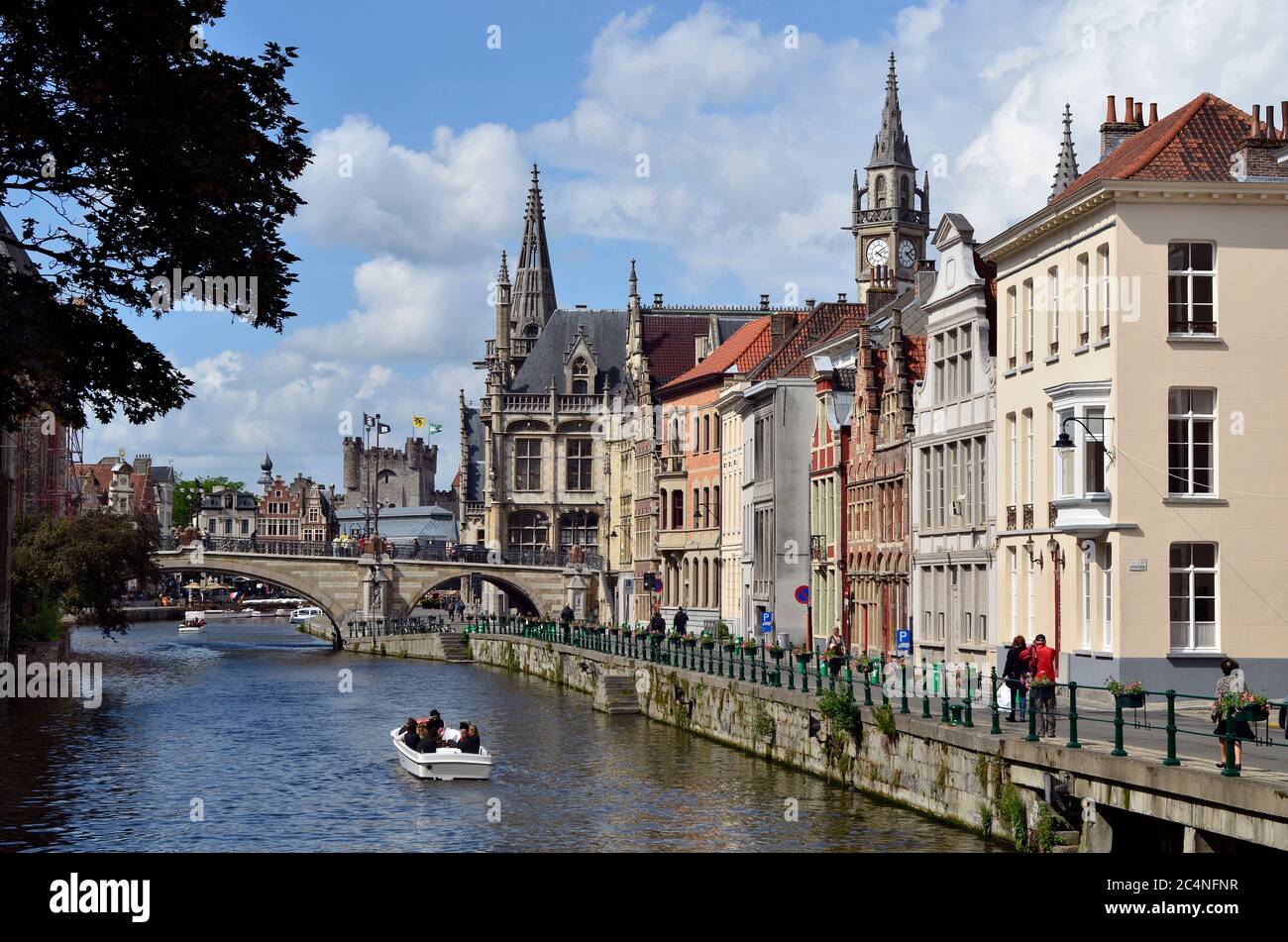 Ghent, Belgium - May 31, 2011: Unidentified people and buildings along river Leie on Graslei district Stock Photo