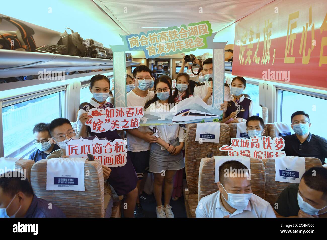 Hefei. 28th June, 2020. Train attendants pose for photos with passengers aboard train No. G9394 travelling from Hefei to Hangzhou on the Shangqiu-Hefei-Hangzhou high-speed railway, June 28, 2020. A new high-speed railway route connecting east and central China started operation on Sunday. With a designed speed of 350 kph, the route connects the city of Shangqiu in central China's Henan Province, and Hefei and Hangzhou, the capital cities of east China's Anhui and Zhejiang provinces. Credit: Liu Junxi/Xinhua/Alamy Live News Stock Photo