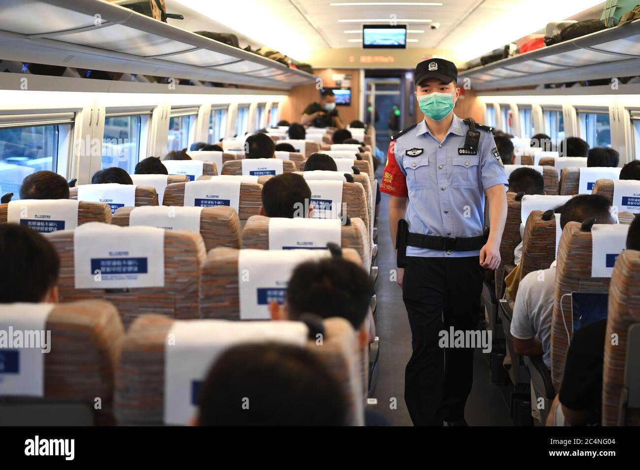 Hefei. 28th June, 2020. A railway police carries out inspection aboard a bullet train travelling from Hefei to Hangzhou on the Shangqiu-Hefei-Hangzhou high-speed railway on June 28, 2020. A new high-speed railway route connecting east and central China started operation on Sunday. With a designed speed of 350 kph, the route connects the city of Shangqiu in central China's Henan Province, and Hefei and Hangzhou, the capital cities of east China's Anhui and Zhejiang provinces. Credit: Liu Junxi/Xinhua/Alamy Live News Stock Photo