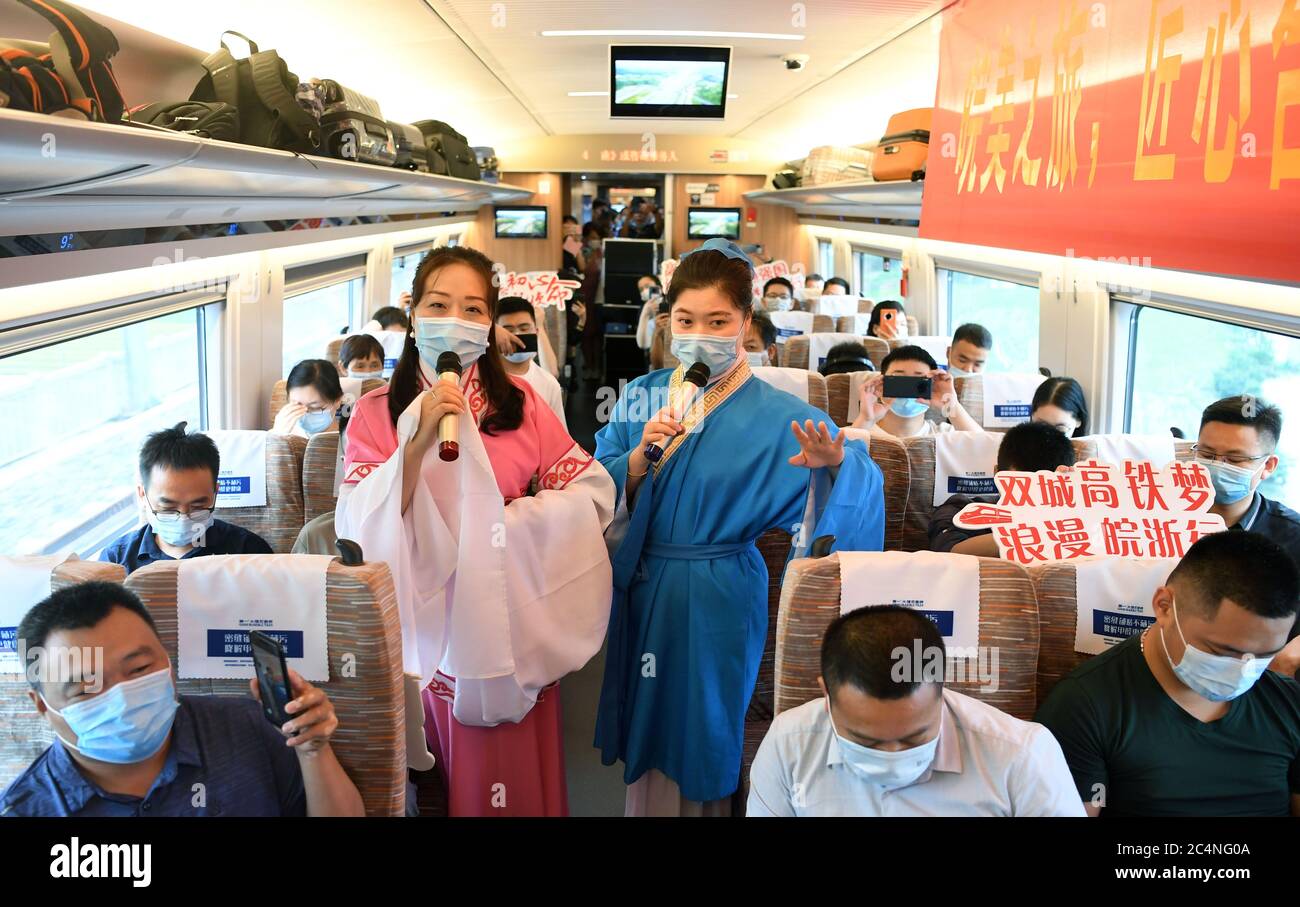 Hefei. 28th June, 2020. Railway staff members stage a performance aboard train No. G9394 travelling from Hefei to Hangzhou on the Shangqiu-Hefei-Hangzhou high-speed railway, June 28, 2020. A new high-speed railway route connecting east and central China started operation on Sunday. With a designed speed of 350 kph, the route connects the city of Shangqiu in central China's Henan Province, and Hefei and Hangzhou, the capital cities of east China's Anhui and Zhejiang provinces. Credit: Liu Junxi/Xinhua/Alamy Live News Stock Photo