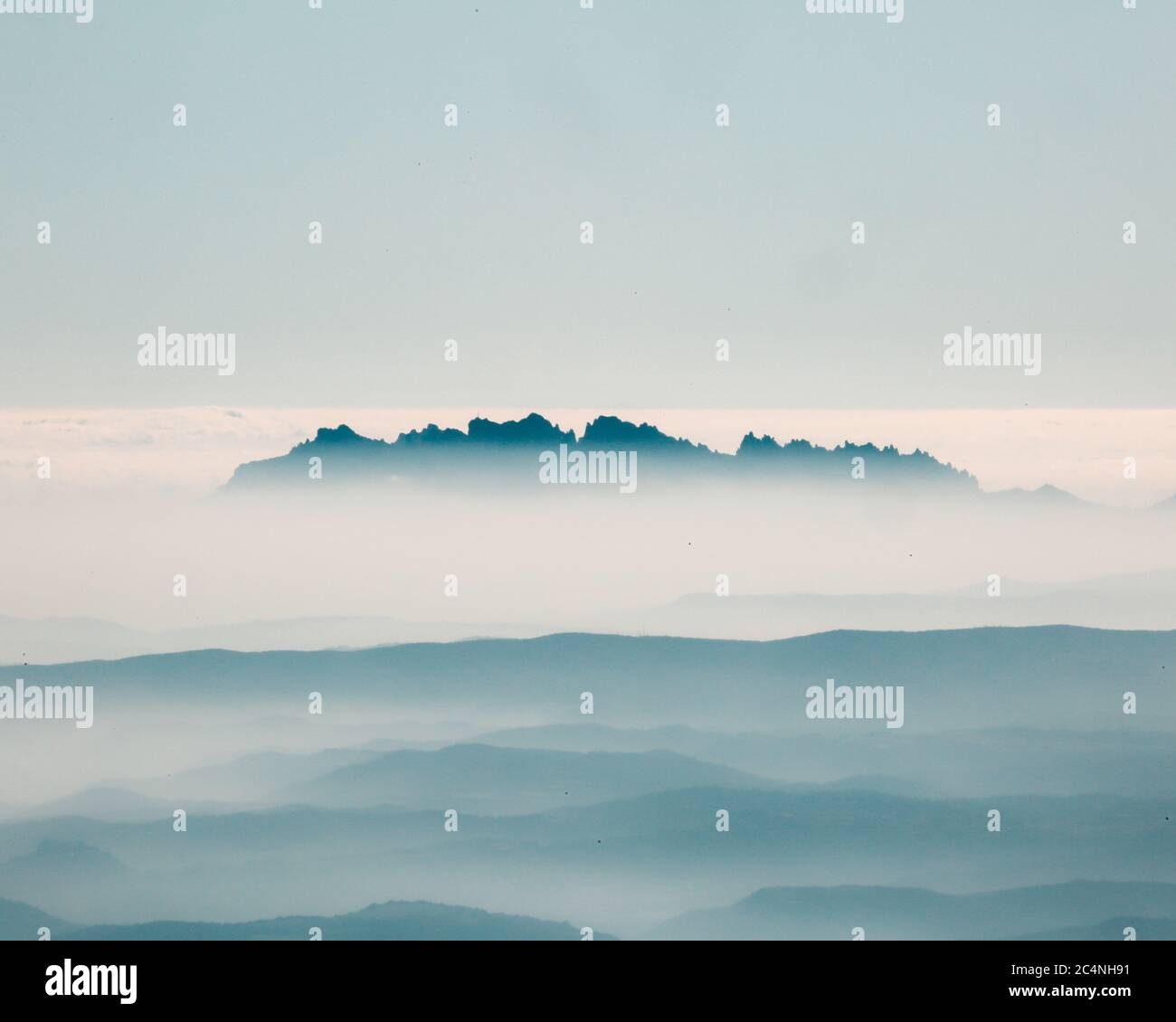 Mountain range with foggy layered landscape Stock Photo - Alamy
