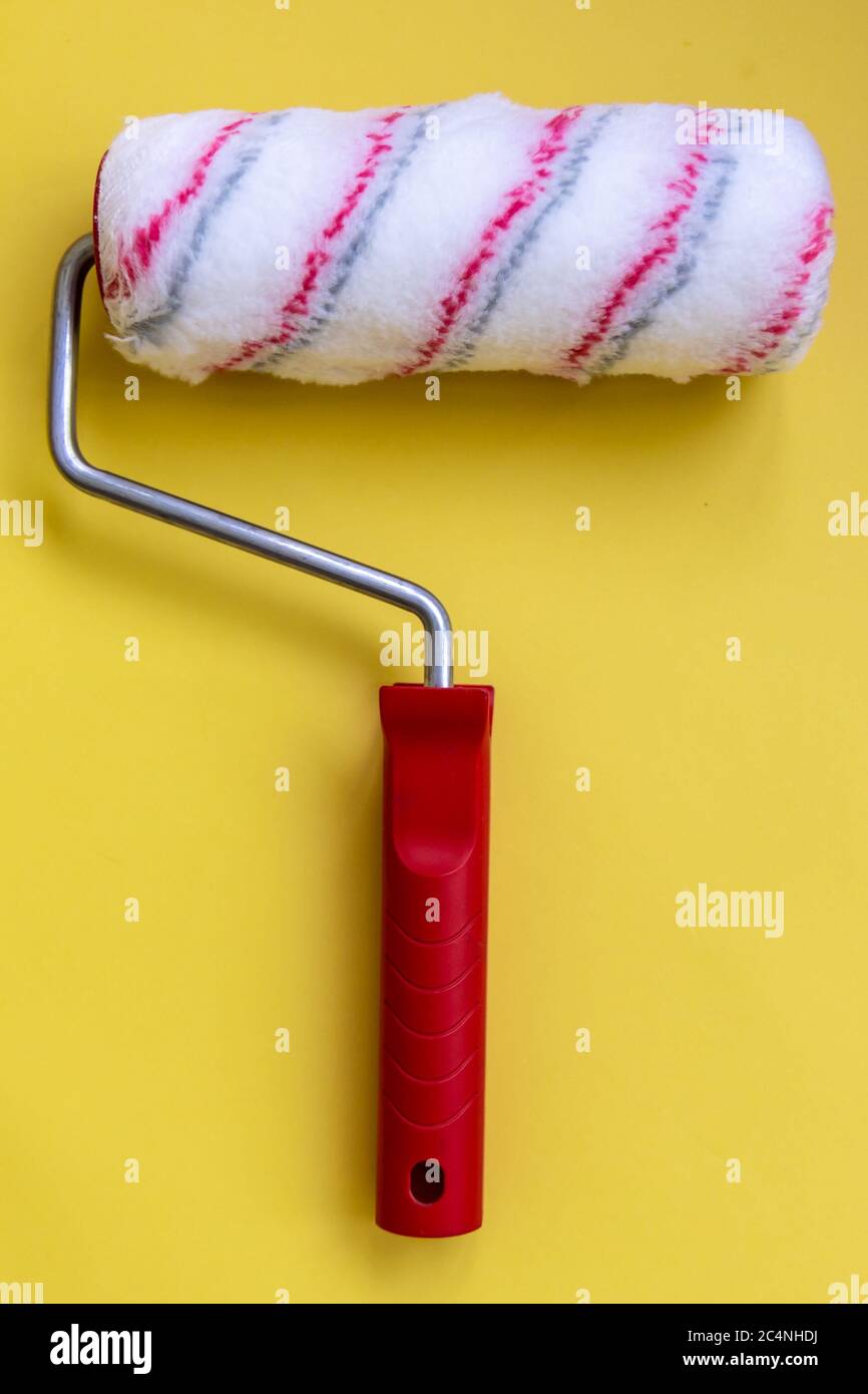 Paint roller for painting and priming new on yellow Background Stock