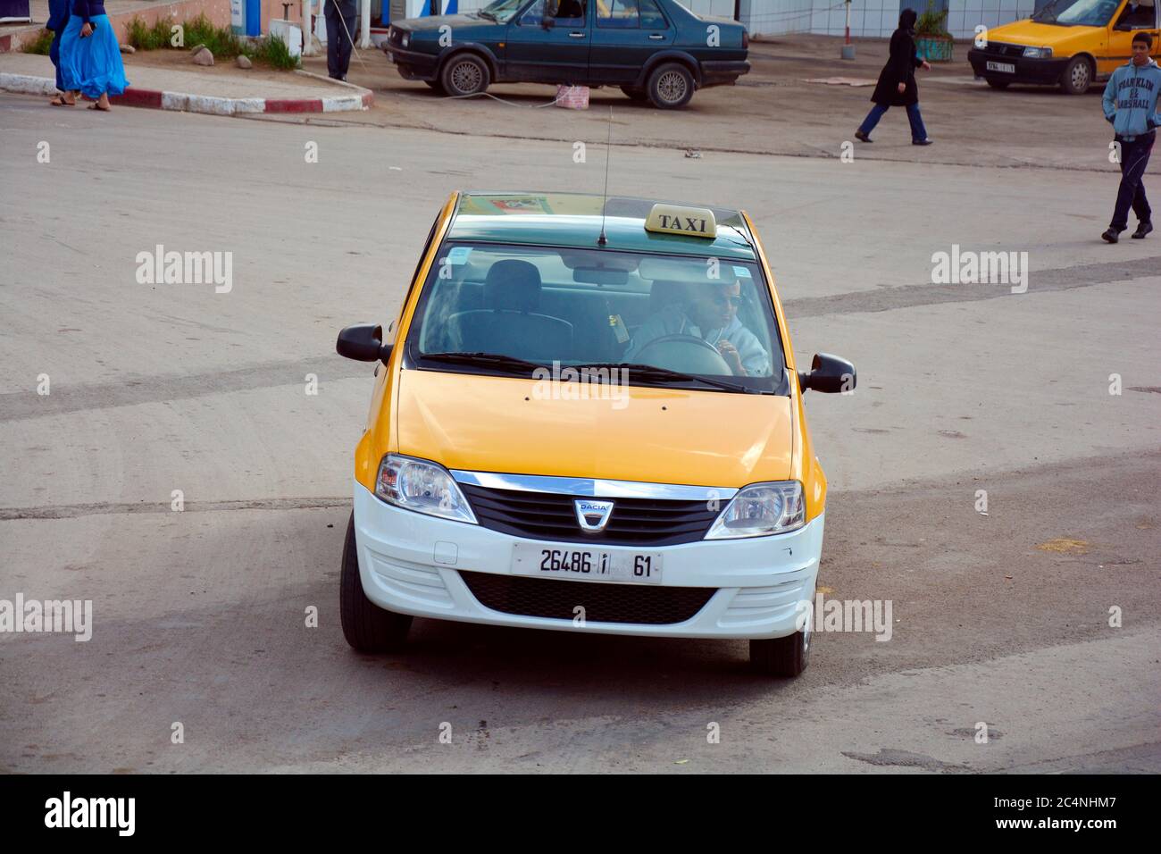 Beni Mellal, Morocco - November 23rd 2014: Unidentified people and Petit Taxi - traditional mode of transport up to four people, the cars have differe Stock Photo