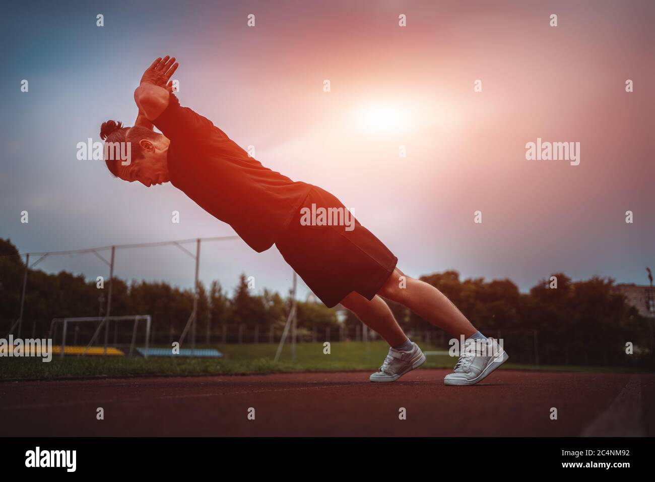 young athlete push up and jump at stadium outdoor Stock Photo
