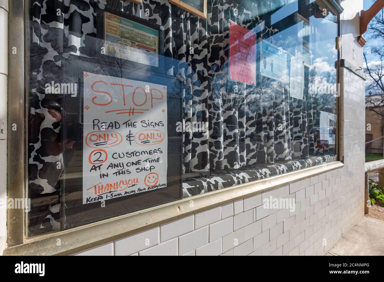 The new normal, A social distancing warning sign in the window of the Rylstone Butchery near Mudgee in New South Wales, Australia Stock Photo
