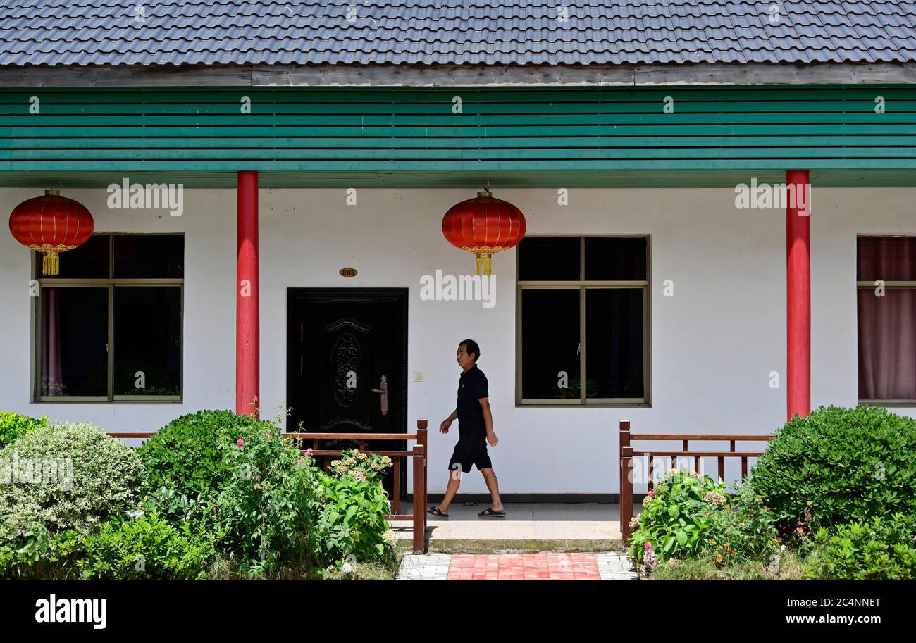 (200628) -- NANCHANG, June 28, 2020 (Xinhua) -- Zhu Yicai conducts guestroom check at his farmhouse in the Poyang Lake scenic area in Yugan County, east China's Jiangxi Province, June 16, 2020. Zhu Yicai gave up his fishing business in 2012 due to the worsening aquatic environment in the Poyang Lake. In 2018, Zhu was running a family farm when he noticed that lots of tourists came to the lake to watch migratory birds. Zhu then captured the business opportunity and opened a 1,800-square-meter farmhouse, which can accommodate more than 200 people dining at the same time. China began a 10-year fi Stock Photo