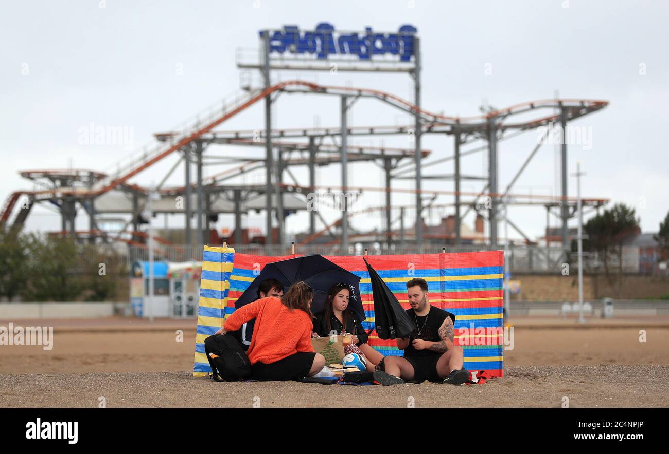 A Family Take Shelter From The Weather On Skegness Beach As Rain Wind A Family Take Shelter From The Weather On Skegness Beach As Rain Wind