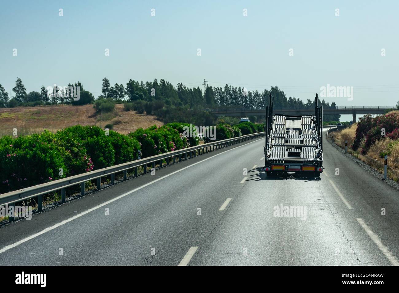 Empty car carrier truck driving on the highway Stock Photo