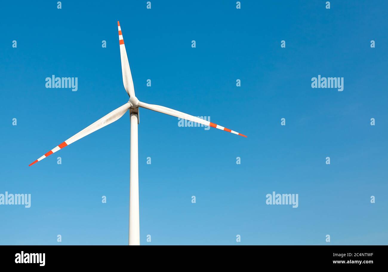 Wind turbine against the blue sky. Stock Photo