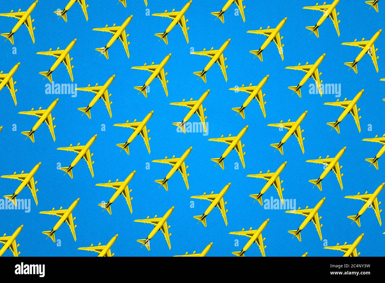 Model of a passenger plane on a blue background. Creative layout of the yellow plane. Minimal concept, travel and recreation. Stock Photo