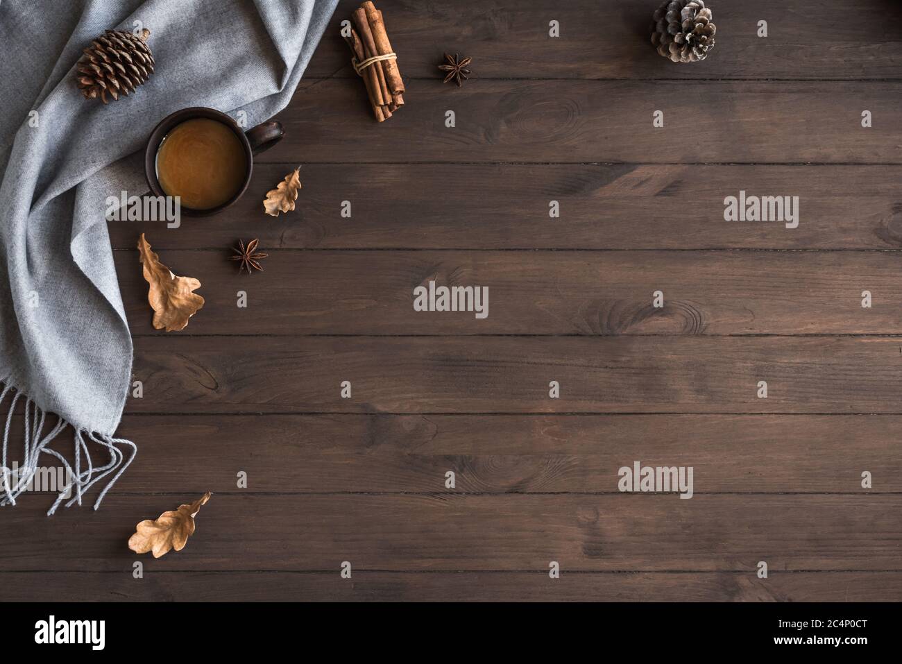 Autumn cozy composition with gray soft plaid and cup of coffee. Seasonal autumnal coziness with warm blanket, coffee, leaves and cones. Cozy home and Stock Photo