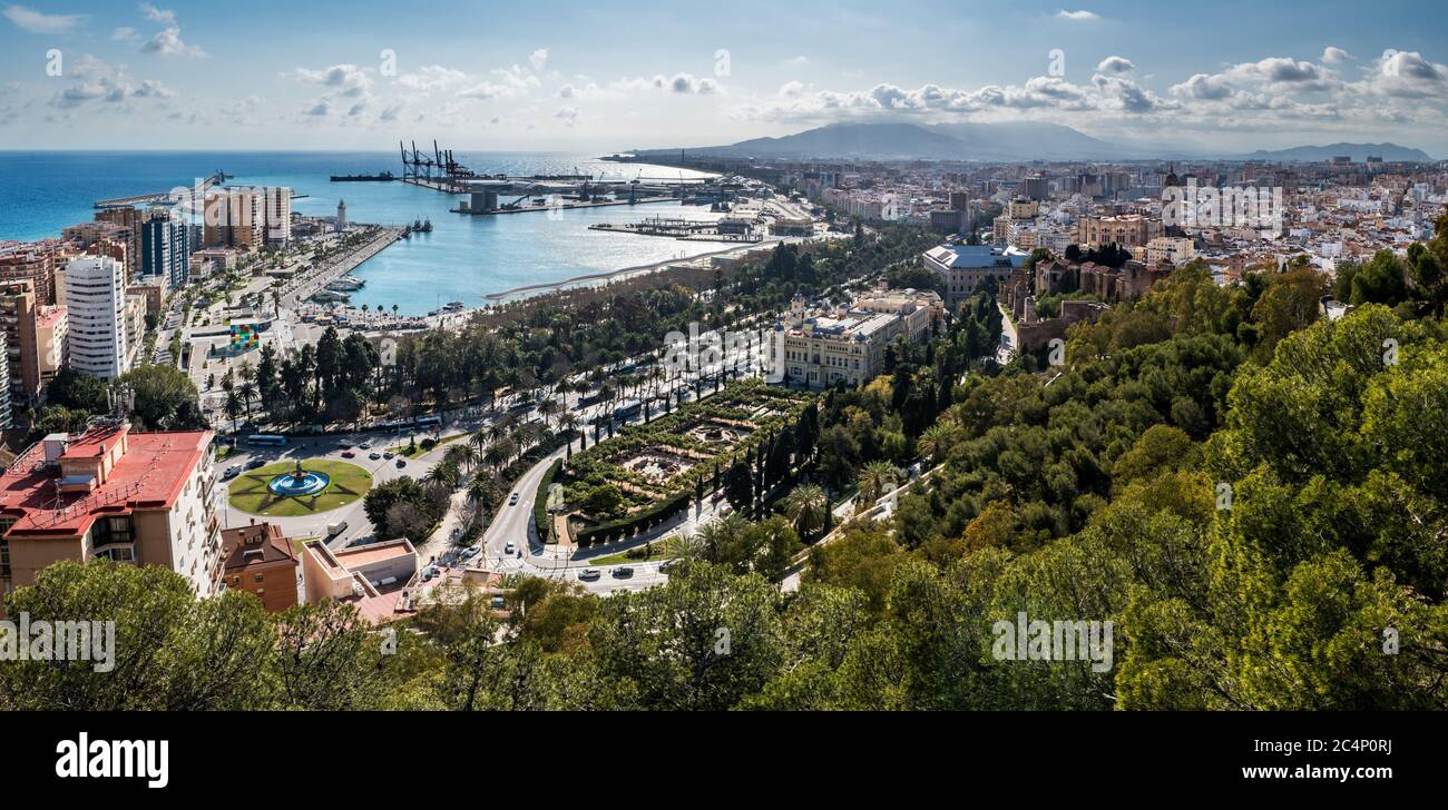 Cityscape of Malaga on a cloudy Winter day, with the harbour and some of the main monuments to be recognised (museum on the left, Cathedral and Alcaza Stock Photo
