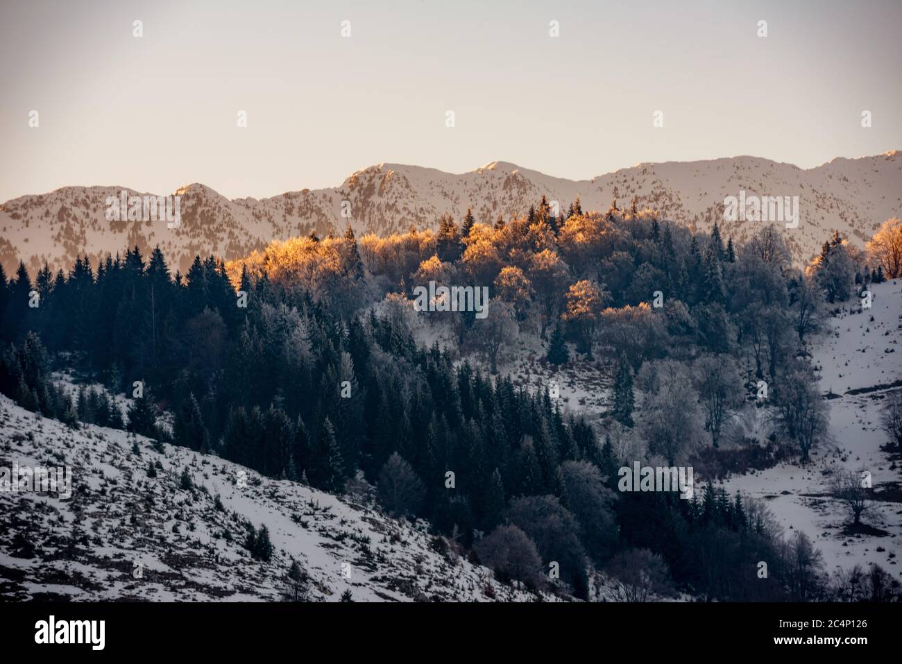 rocky mountains full of snow and villages in the valley Stock Photo - Alamy
