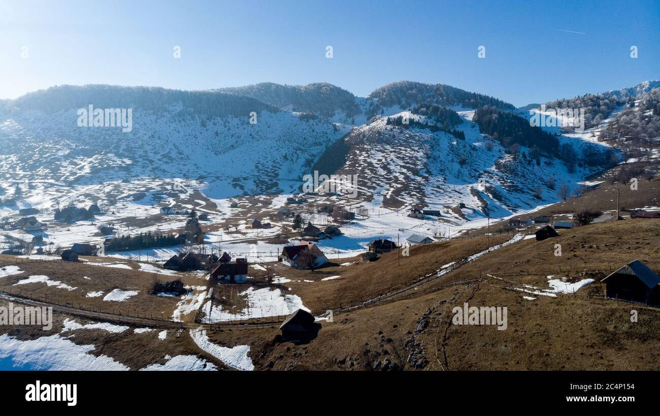 rocky mountains full of snow and villages in the valley Stock Photo - Alamy