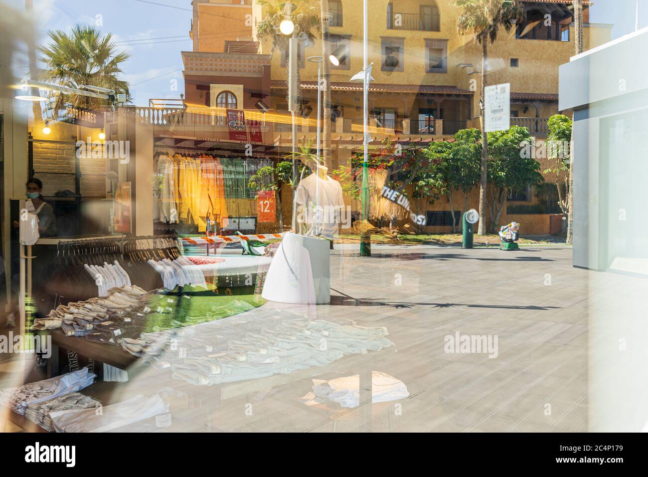 Reflections in windows along the Avenida de Las Américas, nicknamed the  Golden Mile, a shoppers paradise in Playa de Las Americas, in a time of  practically zero tourism with hotels still closed,