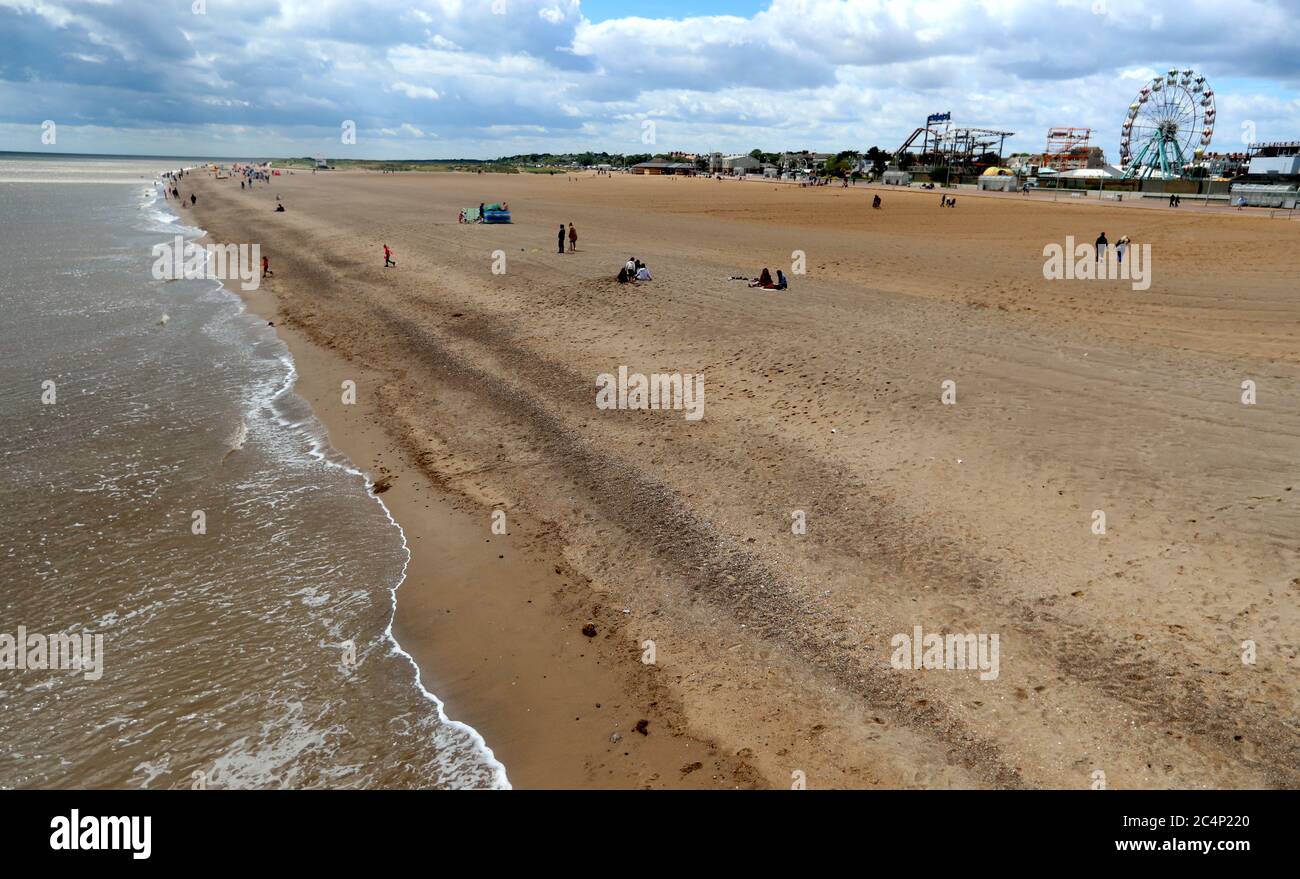 Beach goers brave the weather at Skegness beach, as rain, wind and weather warnings are bringing an end to the sweltering June heatwave. Stock Photo