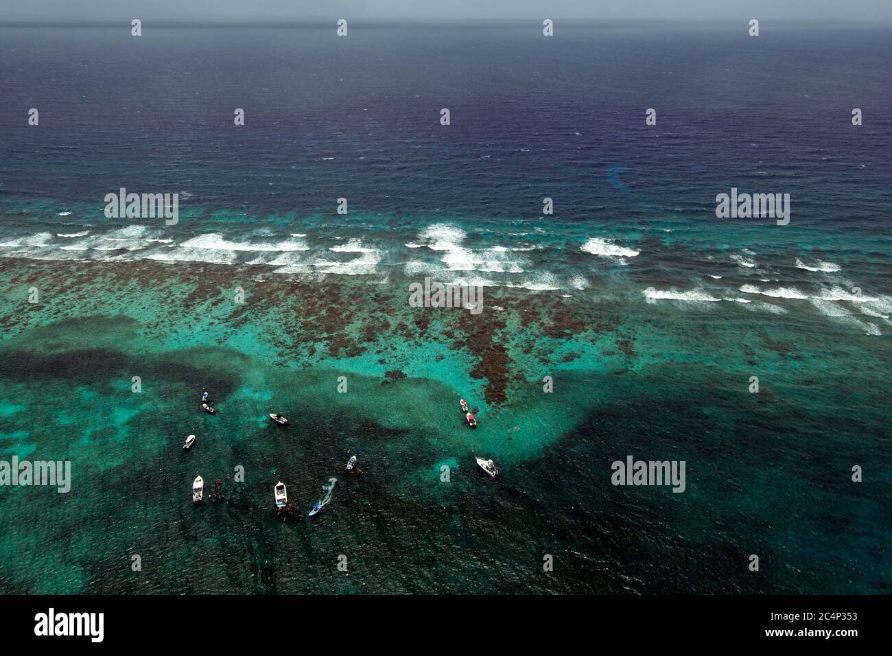 Snorkeling and diving tour boats close to the barrier reef of the Lighthouse Reef Atoll, Belize, Caribbean Sea Stock Photo