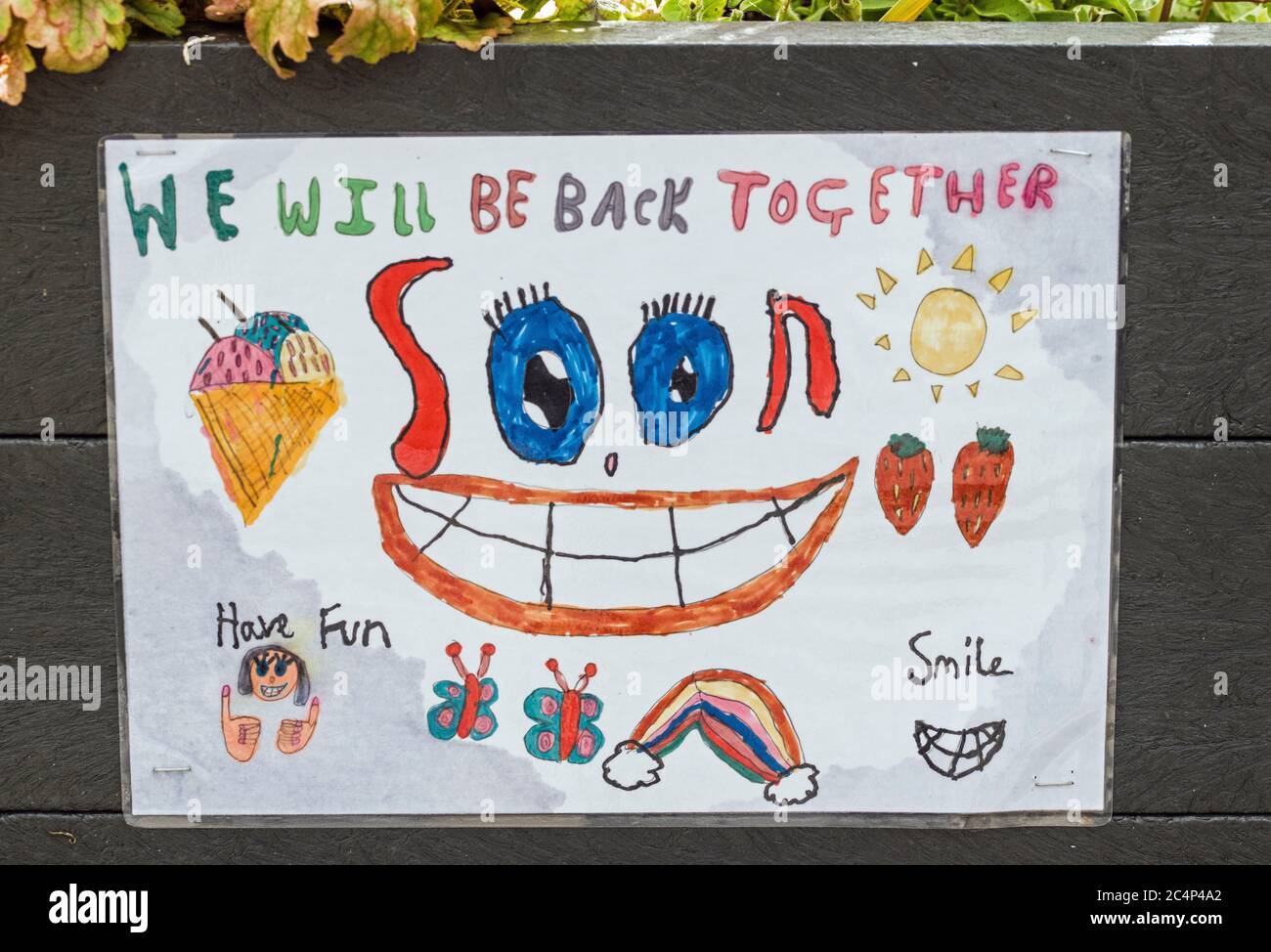 A poster put up by a small child in my village near Cardiff during the Coronavirus lockdown in early 2020. 'We will be back together soon'. Stock Photo