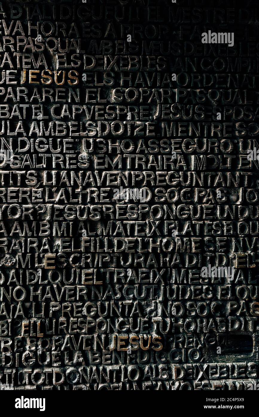 Detail with word Jesus on the bronze door of Passion facade of Sagrada  Familia in Barcelona. The gospel doors contain text from the New Testament  Stock Photo - Alamy