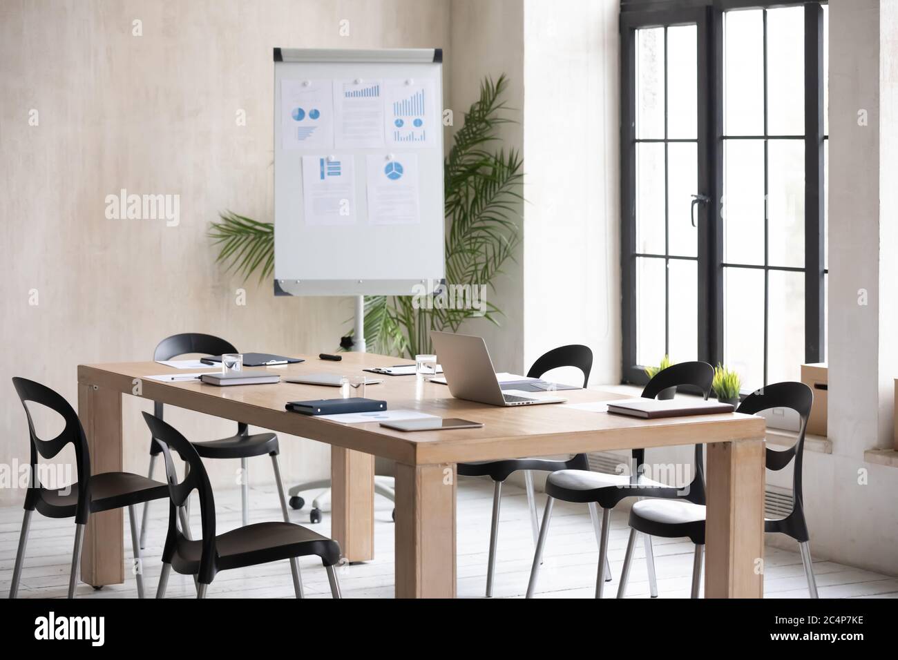 Modern office boardroom with flip chart and conference table Stock Photo
