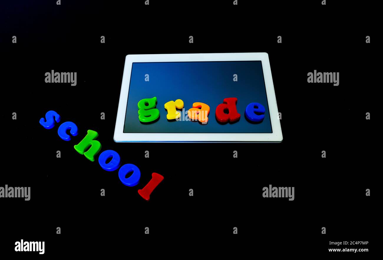 Tablet with text SCHOOL.Tablet PC, technology and education. Back to school concept Stock Photo