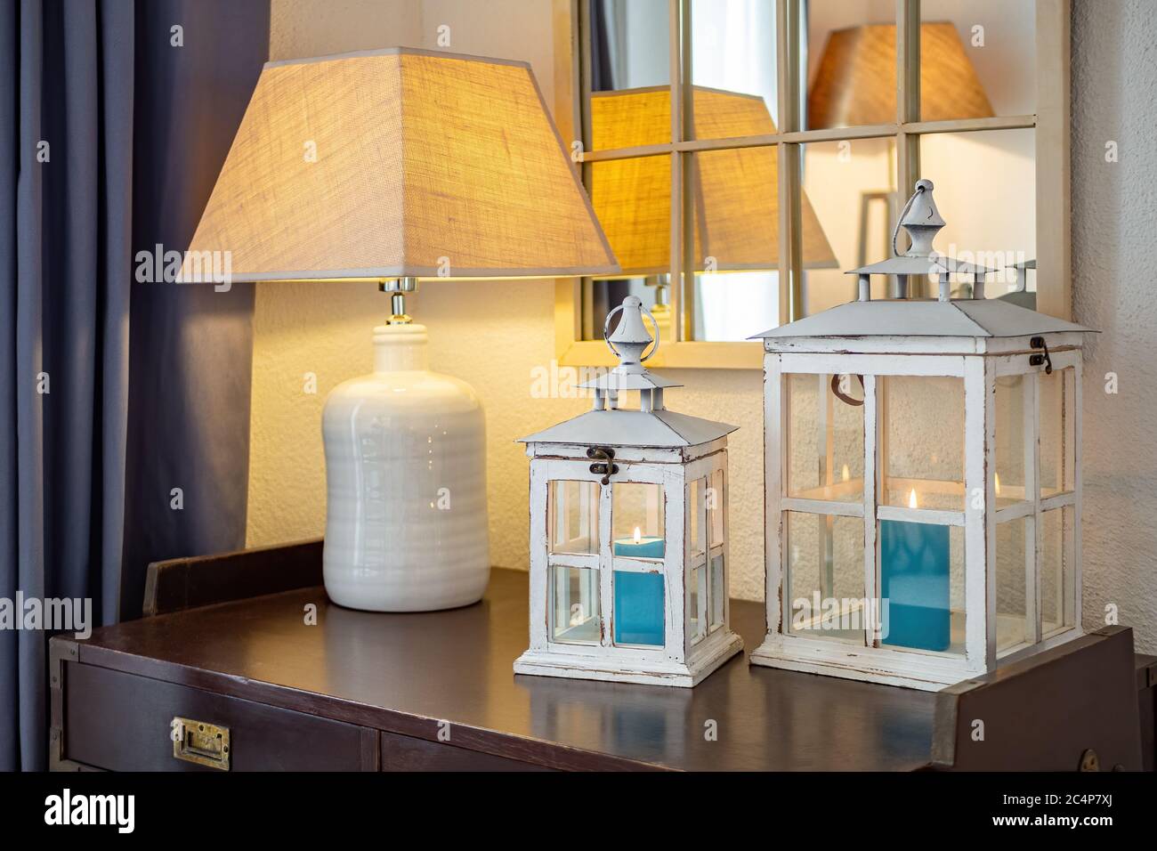 Vintage wooden lanterns, candle holders with blue burning candles