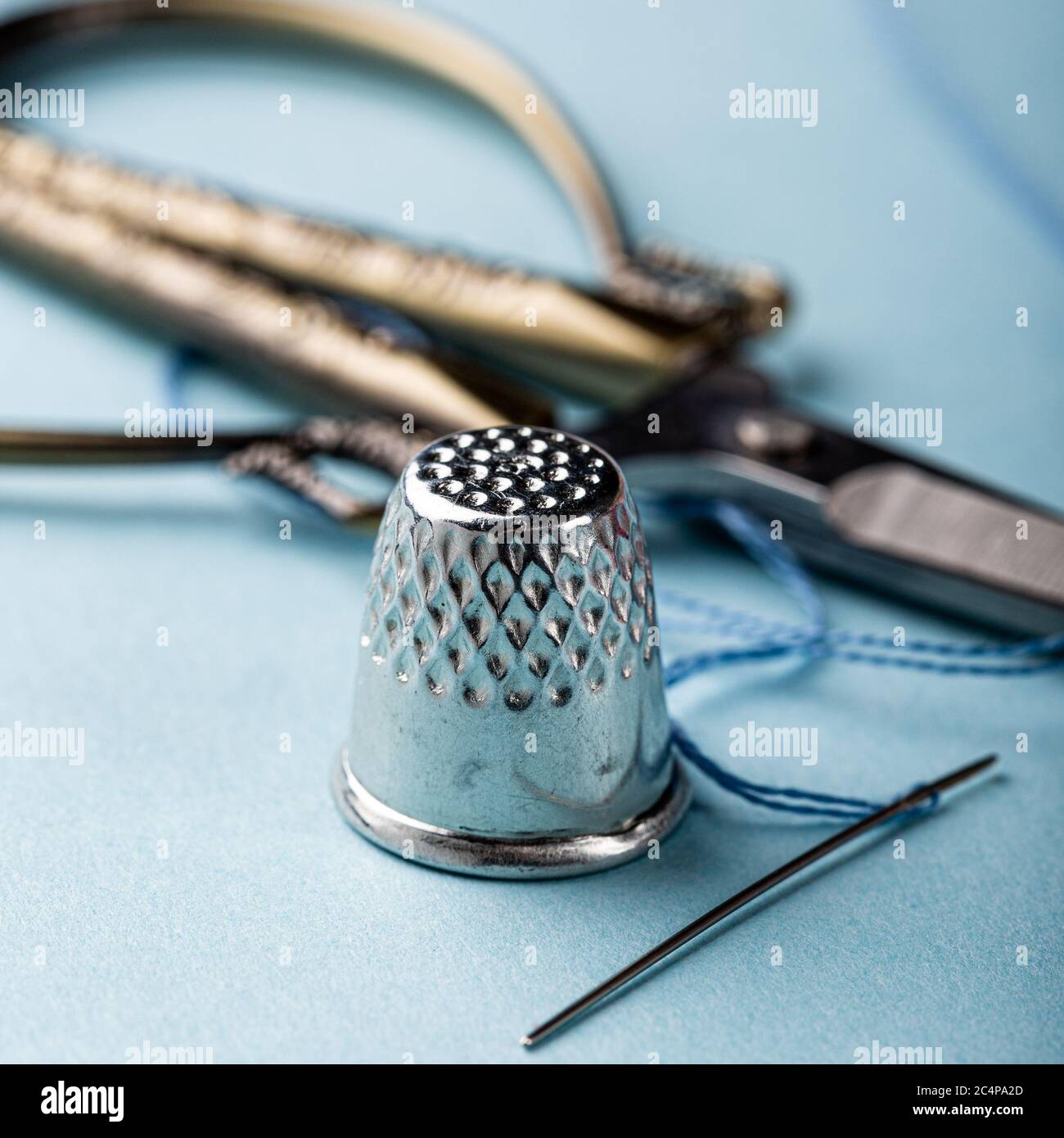 vintage silver thimble on blue Stock Photo