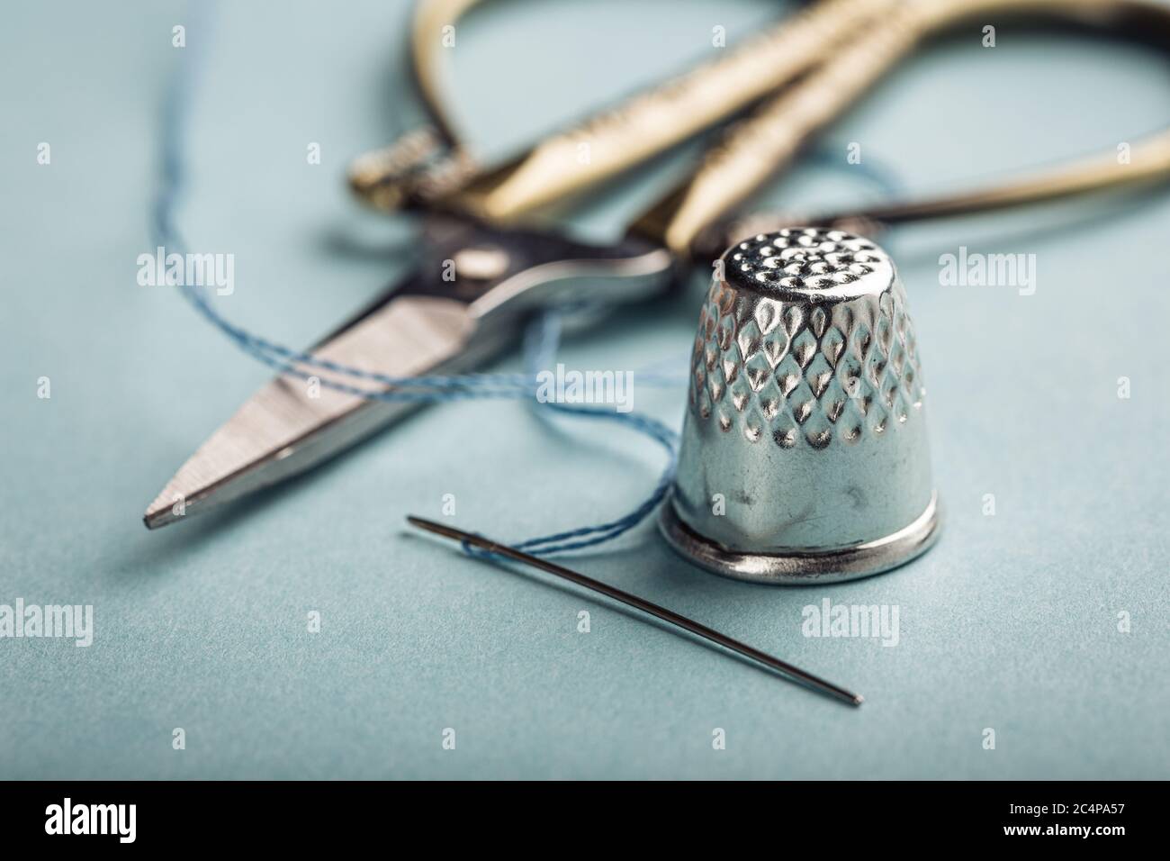 vintage silver thimble on blue Stock Photo
