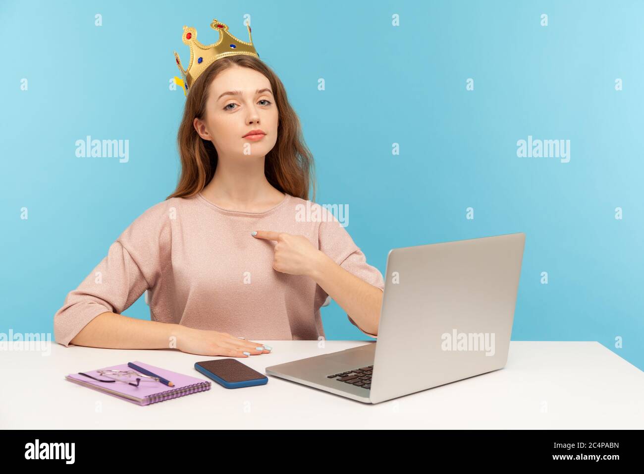 I am leader, big boss. Proud self-confident authoritative businesswoman wearing crown on head and pointing herself, looking with arrogance to camera. Stock Photo